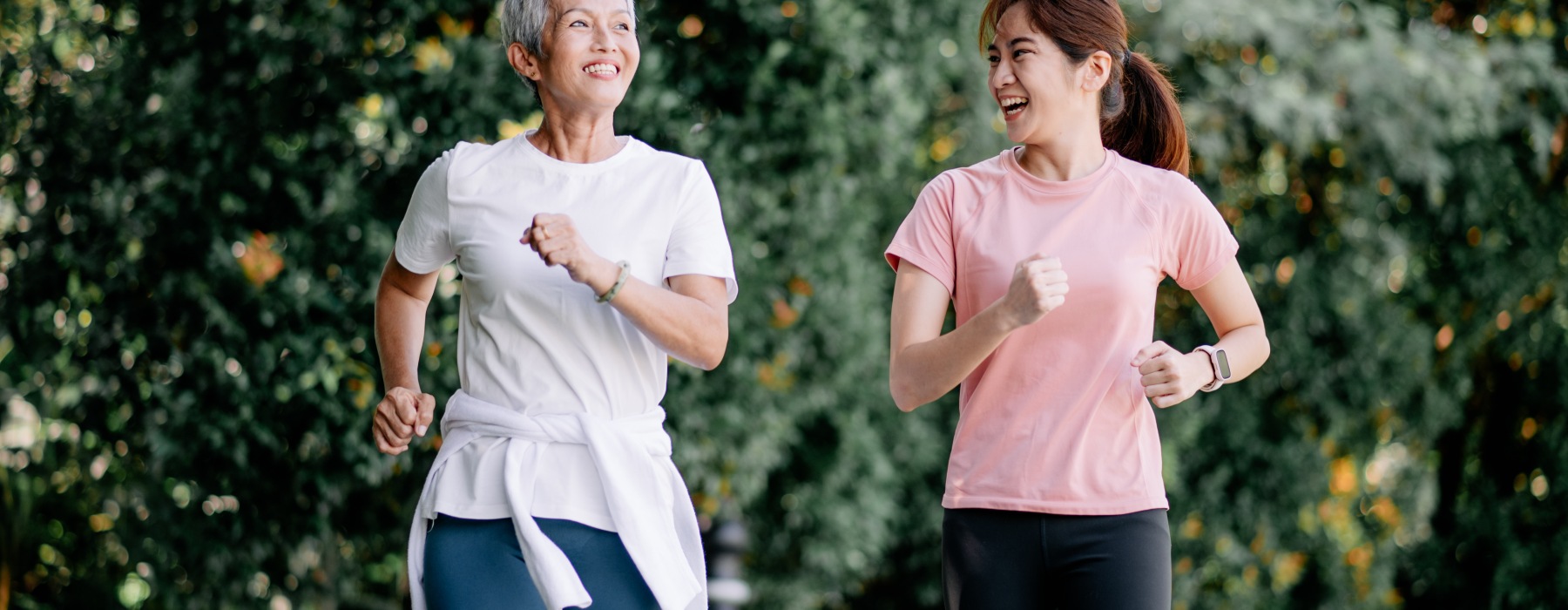 Women jogging through the forest on a path